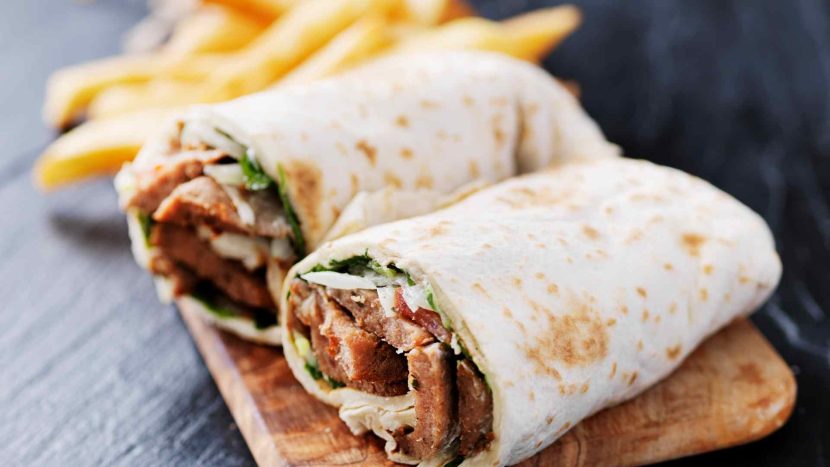 beef wrap on table with potato chips